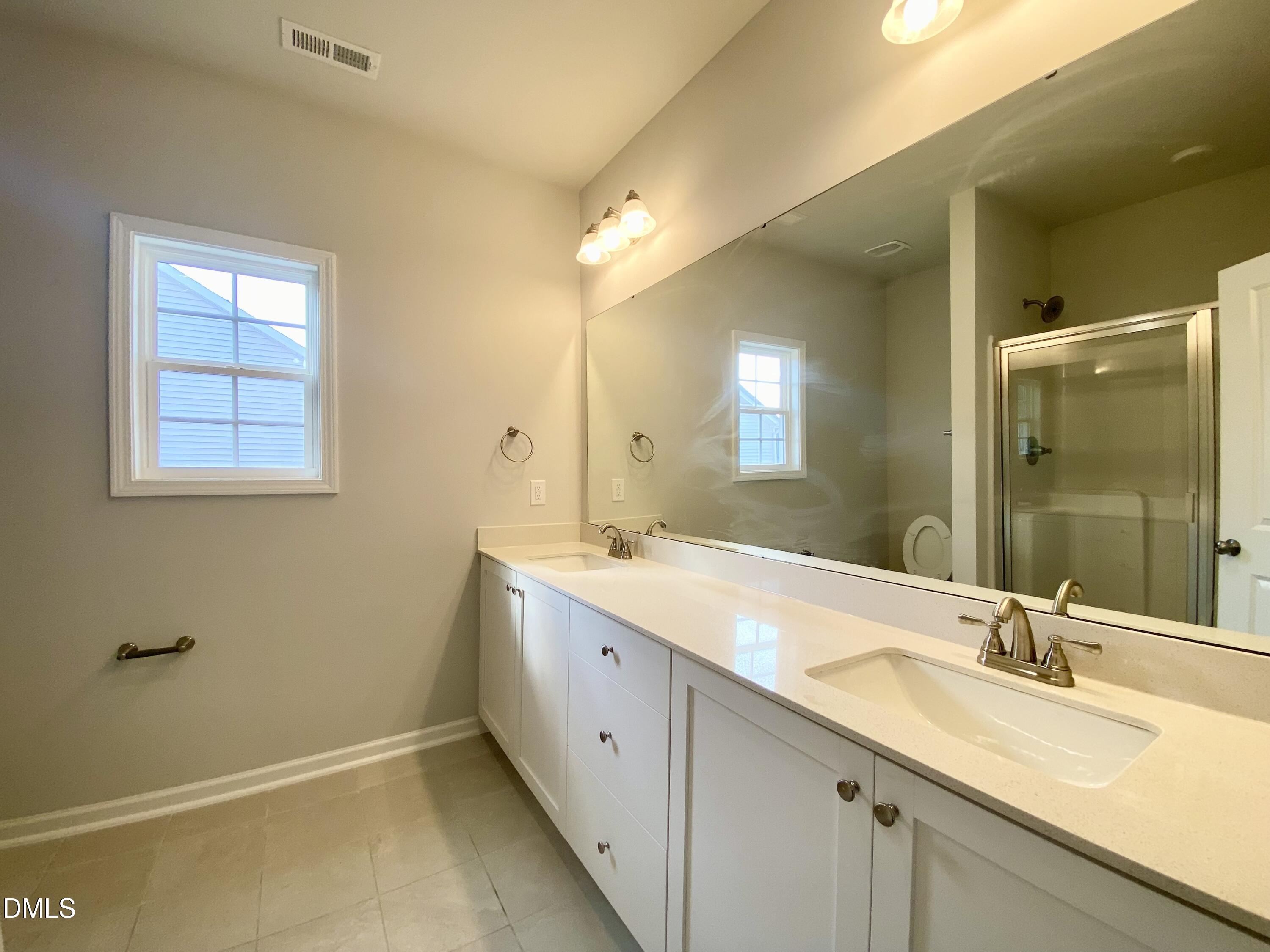 155 Nectar Lane Bunnlevel, NC 28323 - Photo 7 of 16 a bathroom with a double vanity sink and a mirror