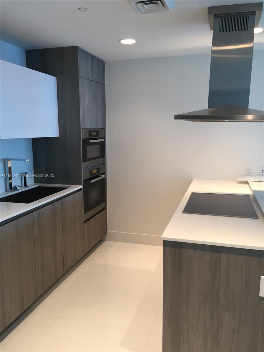 350 Ocean Drive, Unit 704N Key Biscayne, FL 33149 - Photo 15 of 34 a kitchen with a sink a stove and a refrigerator