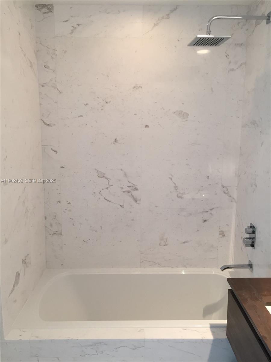 350 Ocean Drive, Unit 704N Key Biscayne, FL 33149 - Photo 22 of 34 a bathroom with bathtub and shower