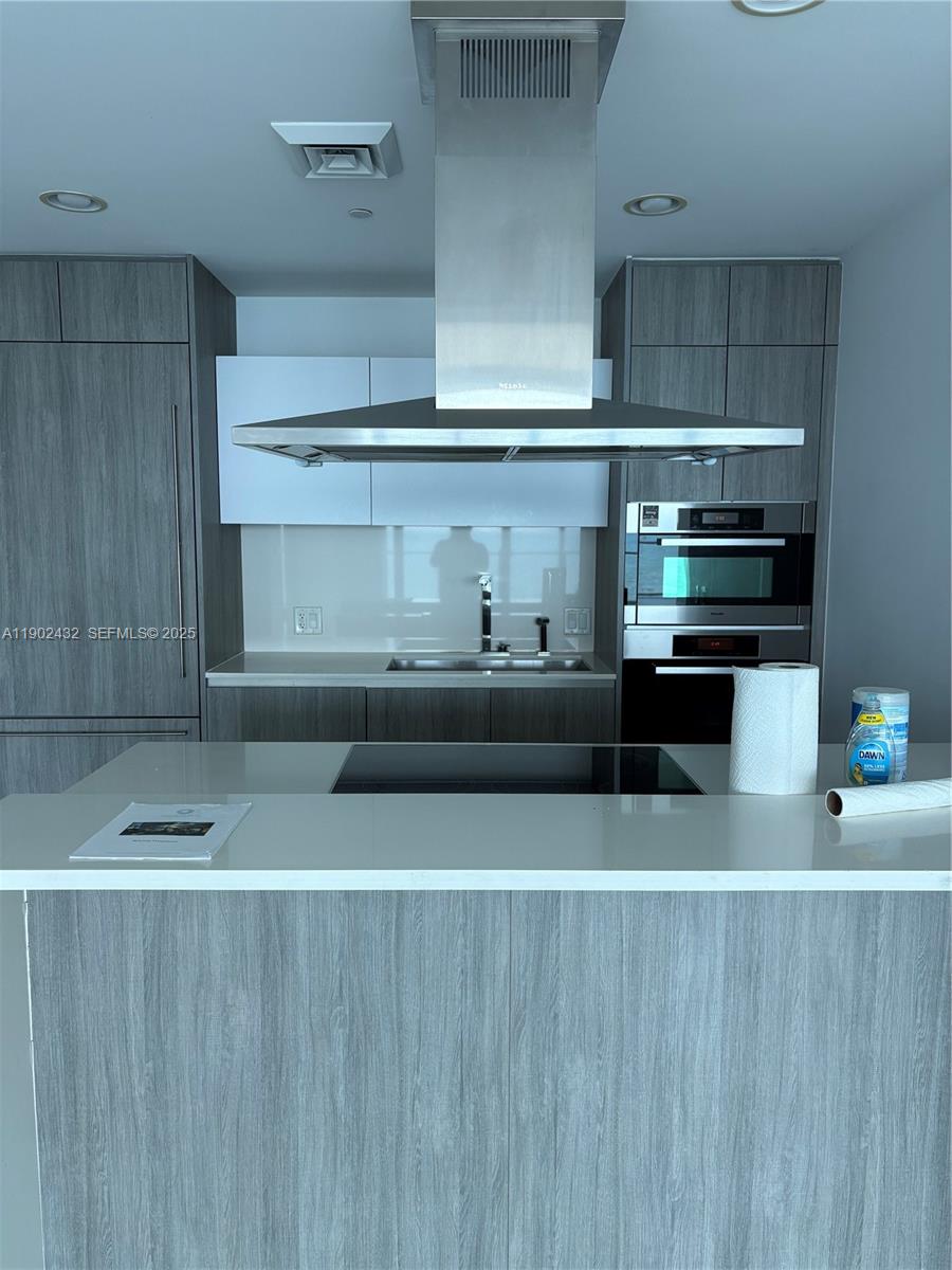 350 Ocean Drive, Unit 704N Key Biscayne, FL 33149 - Photo 33 of 34 a kitchen with a stove and cabinets