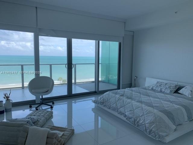 350 Ocean Drive, Unit 704N Key Biscayne, FL 33149 - Photo 4 of 34 a bedroom with a large bed and a large window