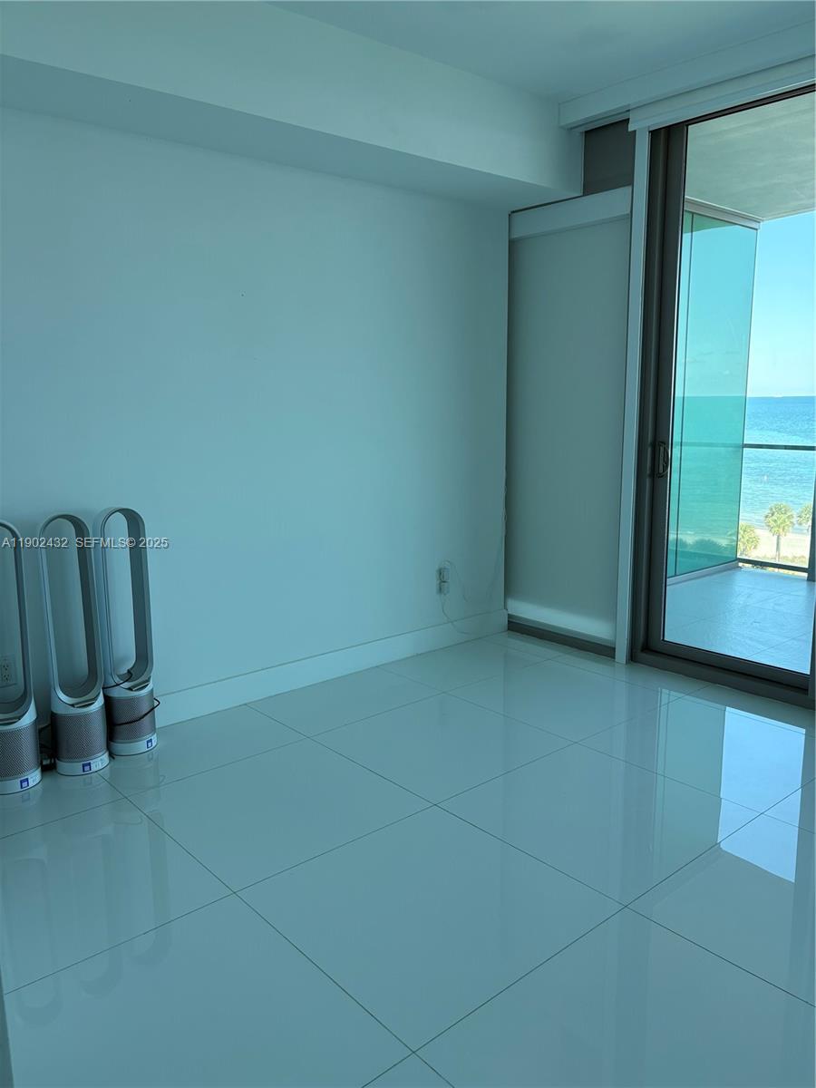 350 Ocean Drive, Unit 704N Key Biscayne, FL 33149 - Photo 8 of 34 a view of a room with door and chair