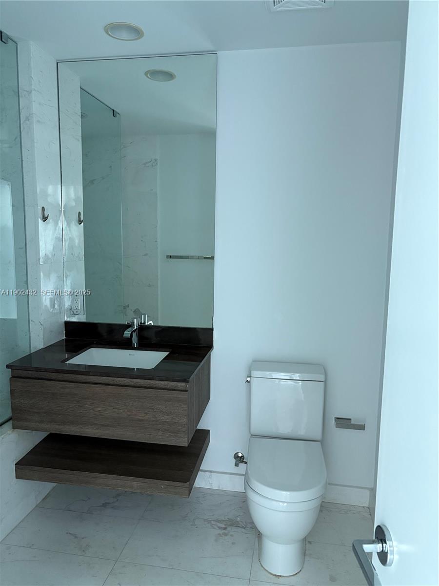 350 Ocean Drive, Unit 704N Key Biscayne, FL 33149 - Photo 9 of 34 a bathroom with a sink and a toilet