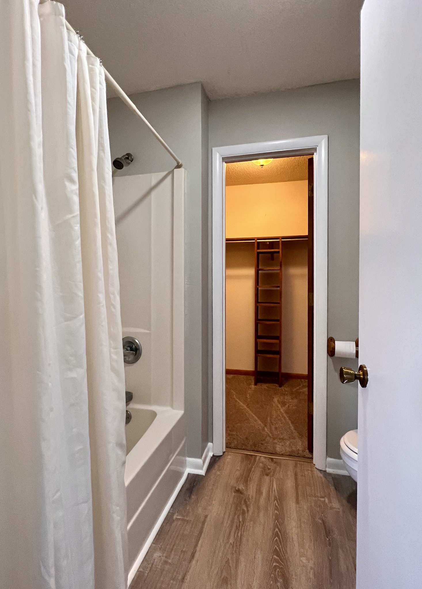 1005 West Point Road Lawrenceburg, TN 38464 - Photo 16 of 28 a view of a hallway with wooden floor and a bathroom