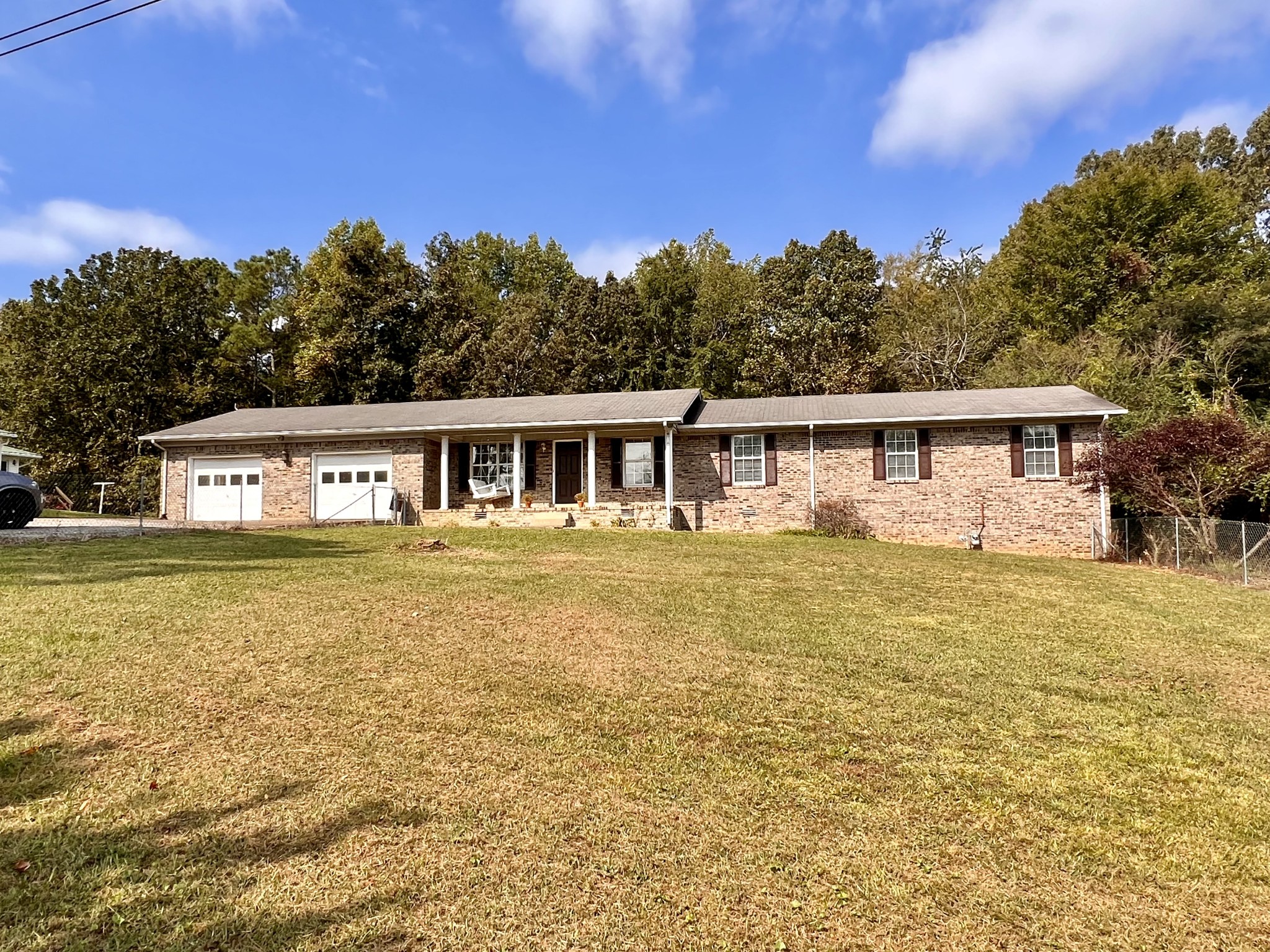 1005 West Point Road Lawrenceburg, TN 38464 - Photo 25 of 28 a front view of house with yard swimming pool and trees in the background