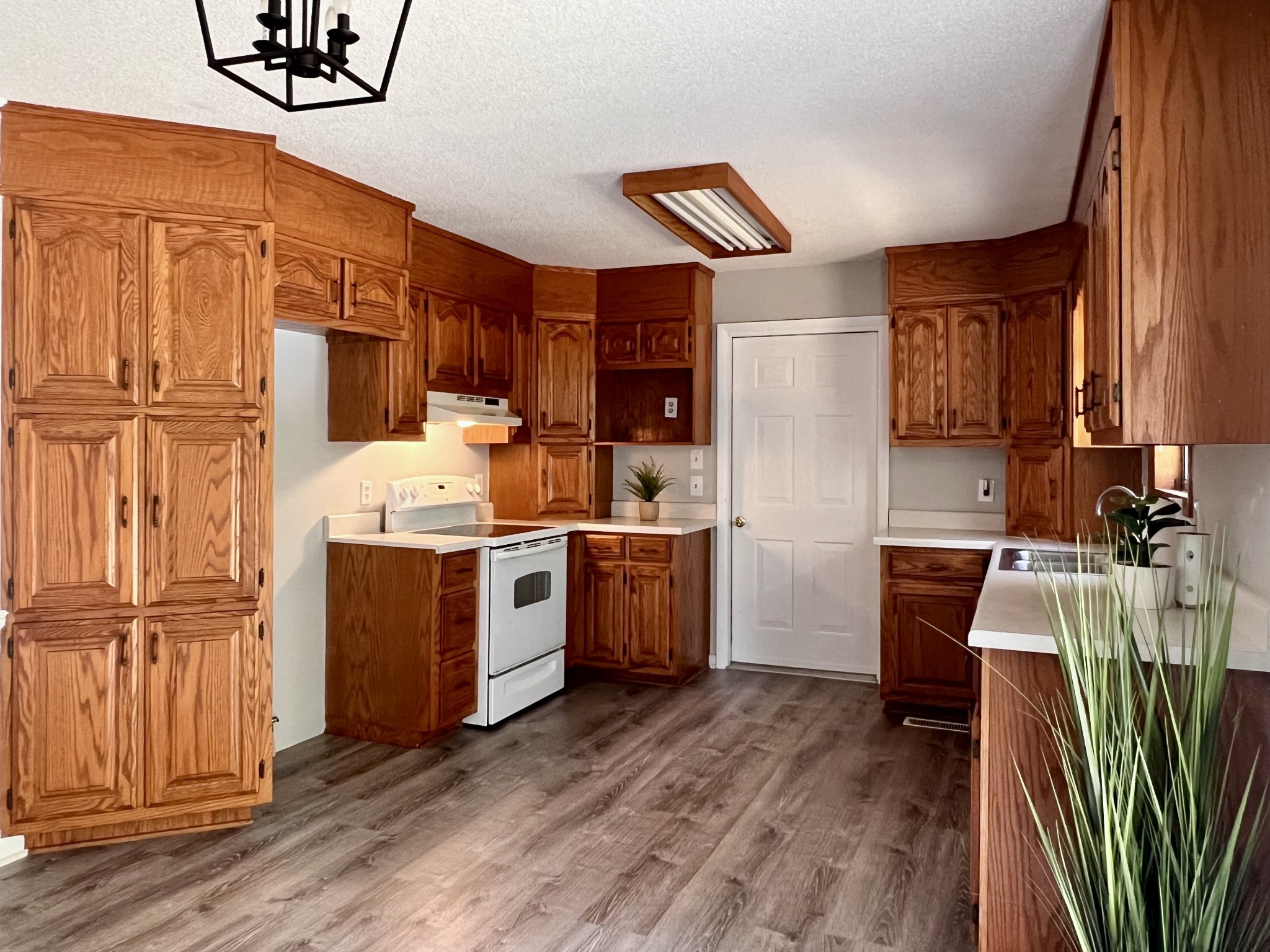 1005 West Point Road Lawrenceburg, TN 38464 - Photo 5 of 28 a kitchen with a refrigerator sink and wooden cabinets