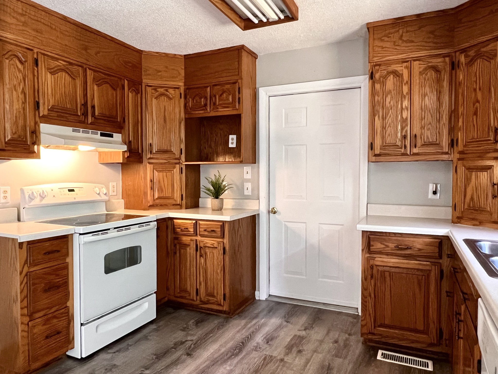 1005 West Point Road Lawrenceburg, TN 38464 - Photo 8 of 28 a kitchen with a refrigerator sink and cabinets