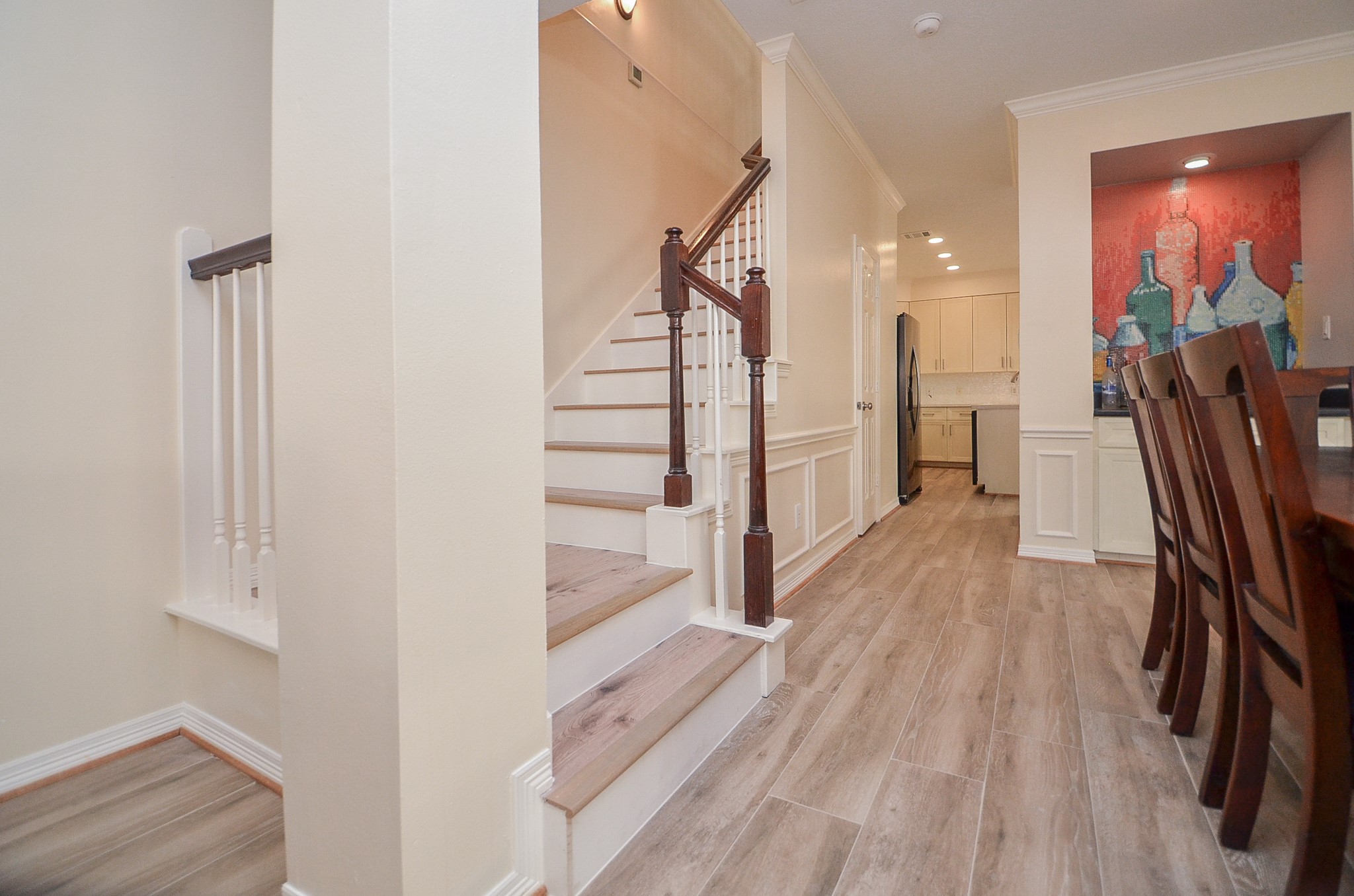 4916 Inker Street Houston, TX 77007 - Photo 19 of 36 As we head upstairs, note the seamless transition from the wood floors to the vinyl plank flooring! -- which continues into the second level.