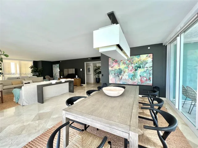 a kitchen with a table chairs stove and white cabinets
