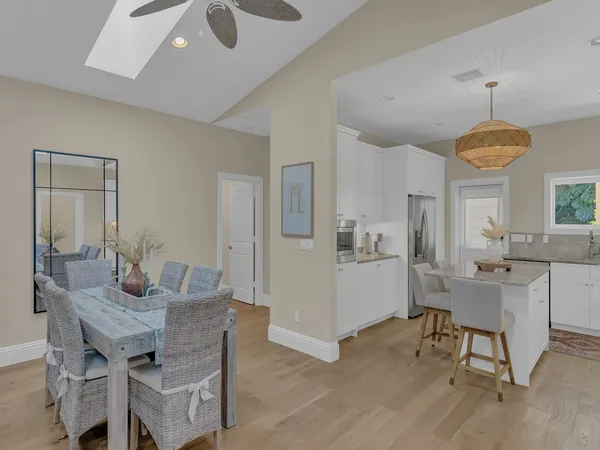 a view of a dining room with furniture and a chandelier