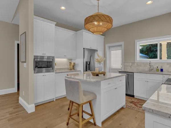 a kitchen with stainless steel appliances a sink and cabinets
