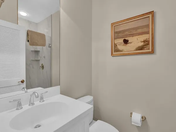 a bathroom with a toilet sink and mirror