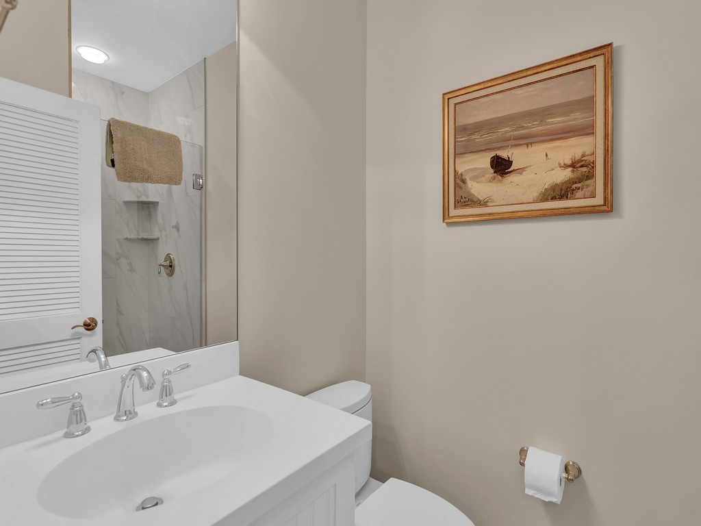 548 Conn Way Vero Beach, FL 32963 - Photo 16 of 35 a bathroom with a toilet sink and mirror