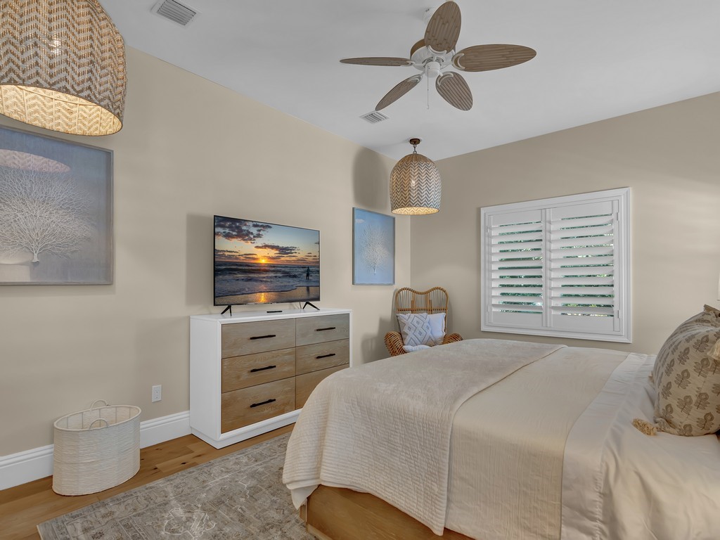 548 Conn Way Vero Beach, FL 32963 - Photo 18 of 35 a bedroom with a bed and a flat tv screen on dresser