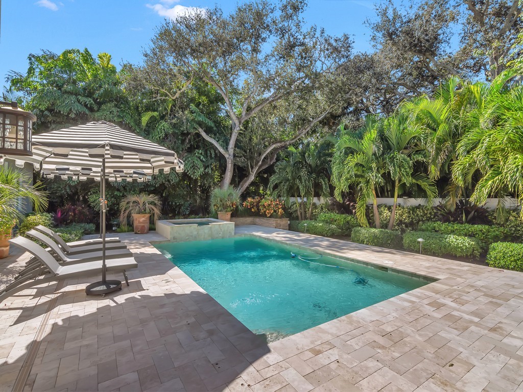 548 Conn Way Vero Beach, FL 32963 - Photo 2 of 35 a view of a patio with a table and chairs under an umbrella