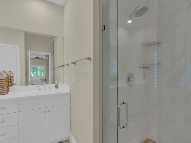 a bathroom with a sink vanity granite tub and shower