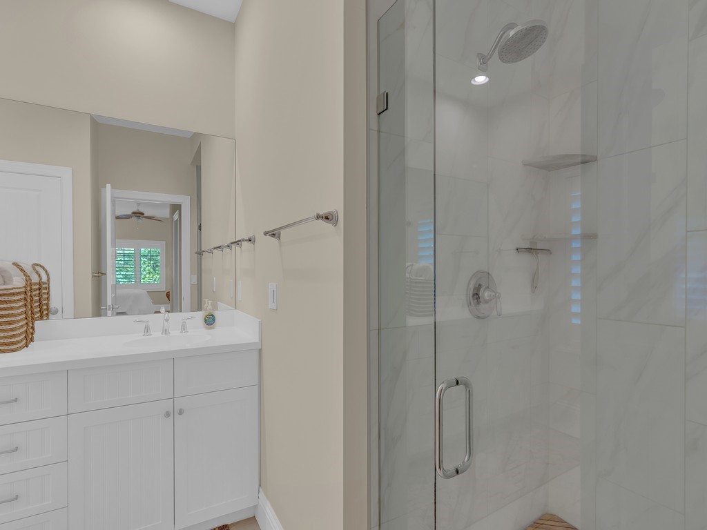 548 Conn Way Vero Beach, FL 32963 - Photo 24 of 35 a bathroom with a sink vanity granite tub and shower