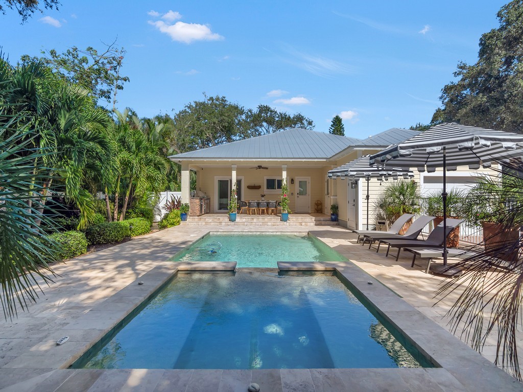 548 Conn Way Vero Beach, FL 32963 - Photo 27 of 35 a view of a patio with table and chairs under an umbrella