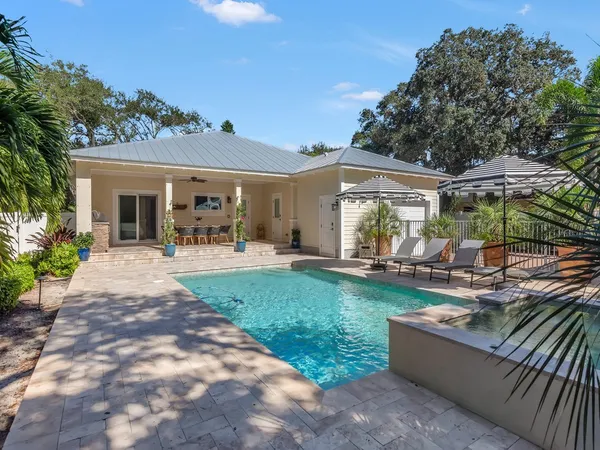a view of a house with backyard porch and sitting area