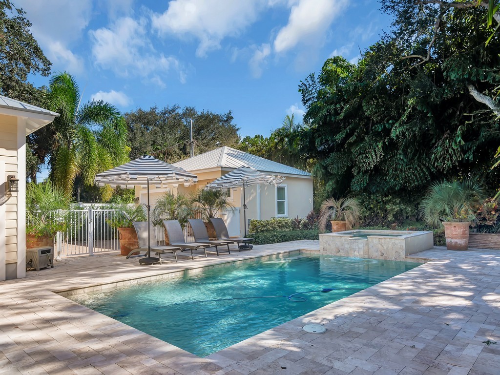 548 Conn Way Vero Beach, FL 32963 - Photo 29 of 35 a view of a patio with table and chairs under an umbrella
