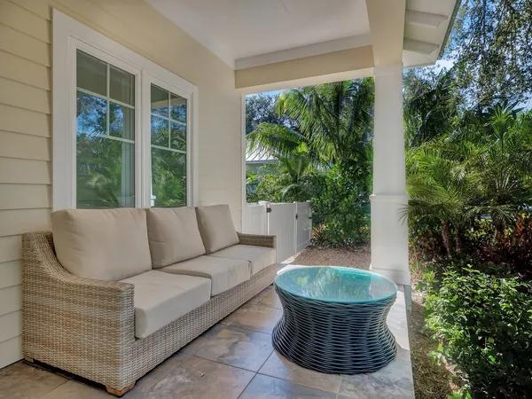 a living room with a couch and a potted plant