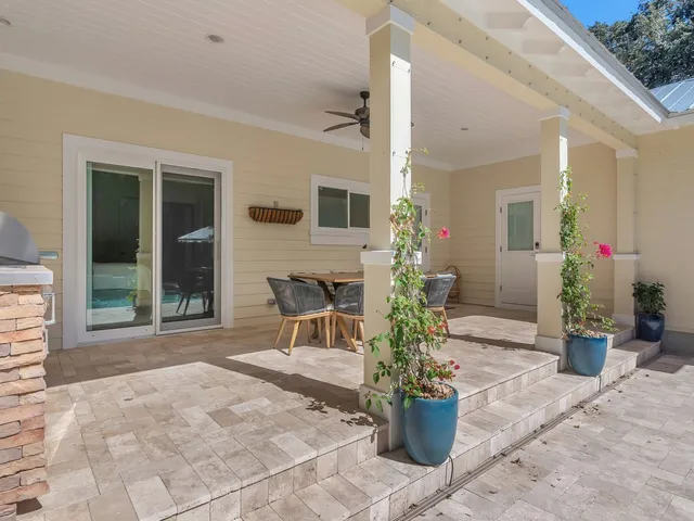 a building outdoor space with patio furniture and potted plants