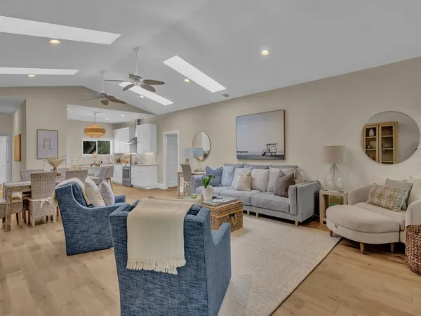 a living room with furniture and a large mirror