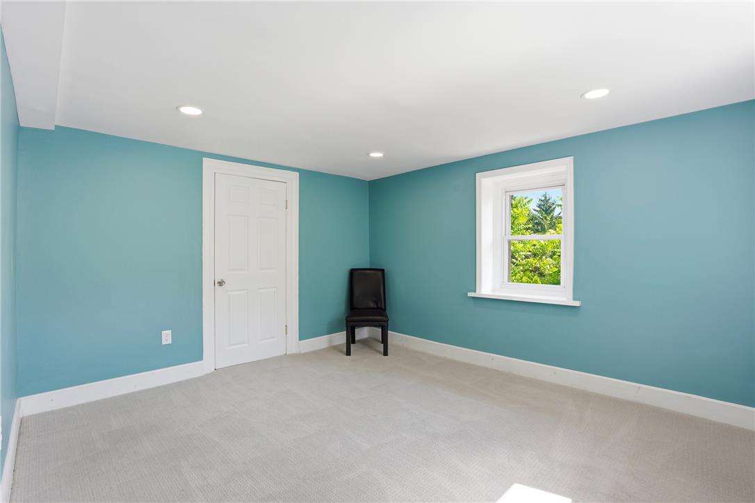 6271 Batman Road Zionsville, PA 18092 - Photo 54 of 100 A well-lit room offering plush carpeting and a serene view of the surrounding trees.
