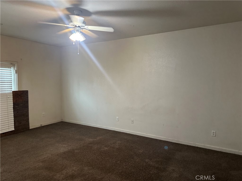 692 Gateway Circle Merced, CA 95340 - Photo 13 of 24 an empty room with a fan & a window