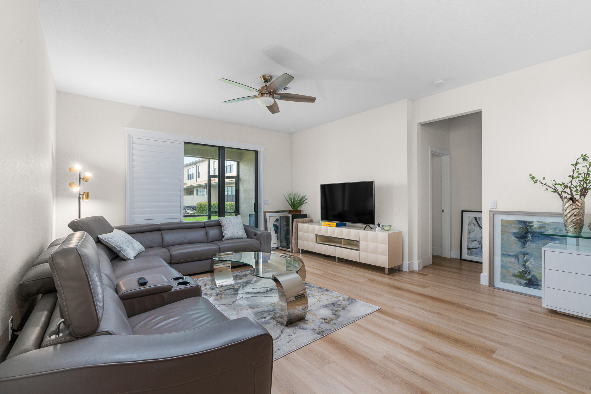8202 Cadre Noir Road Lake Worth, FL 33467 - Photo 12 of 58 a living room with furniture and a flat screen tv