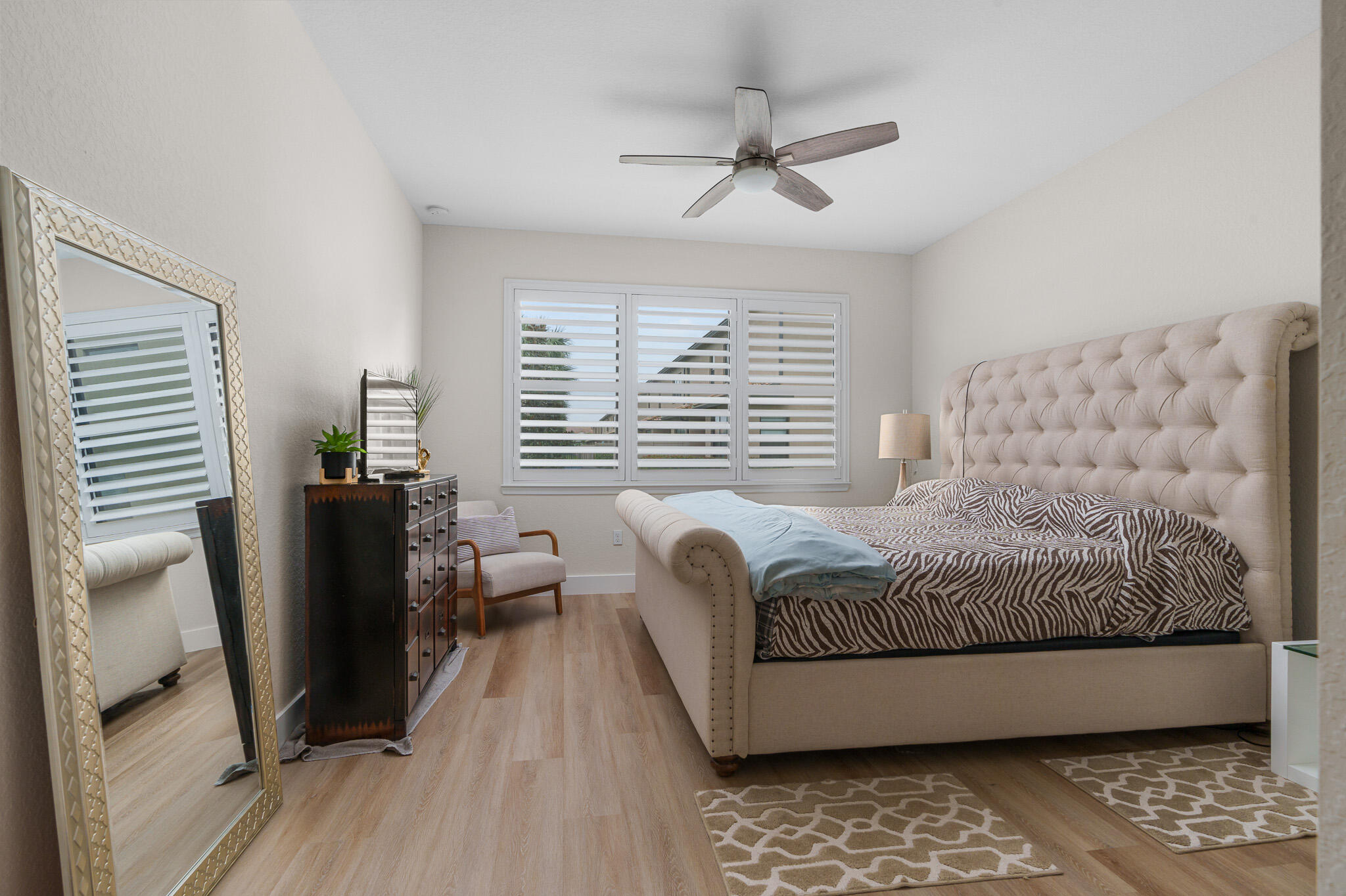 8202 Cadre Noir Road Lake Worth, FL 33467 - Photo 13 of 58 a bedroom with a bed and wooden floor