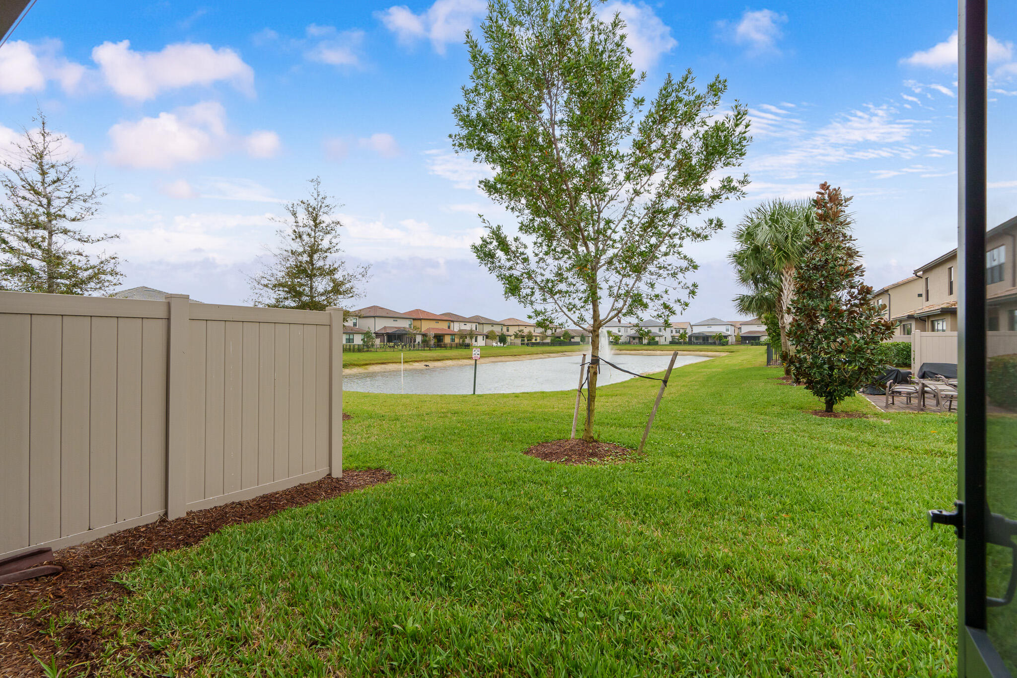 8202 Cadre Noir Road Lake Worth, FL 33467 - Photo 21 of 58 a view of a backyard with green space