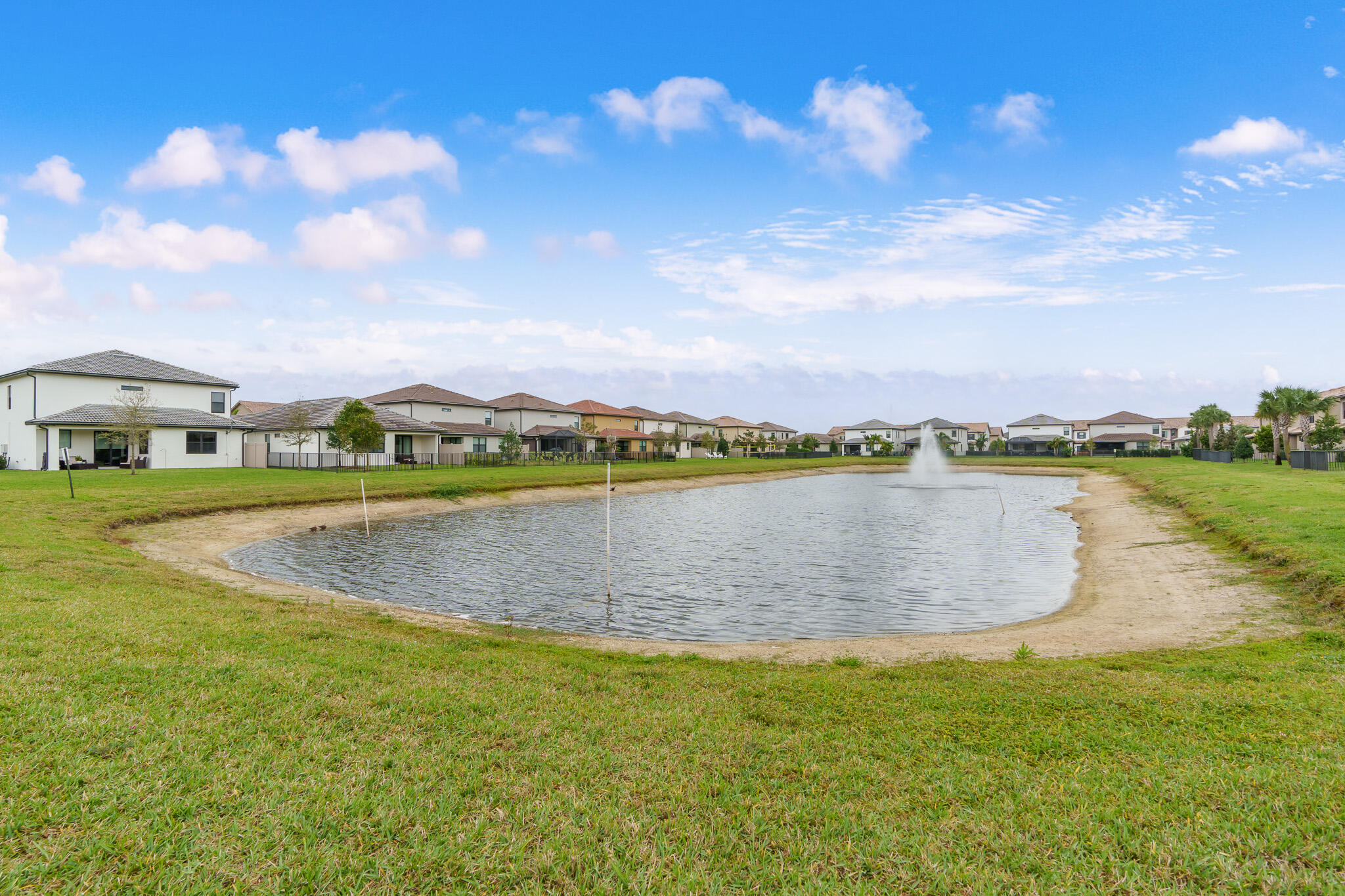 8202 Cadre Noir Road Lake Worth, FL 33467 - Photo 26 of 58 a view of a lake with houses in the back