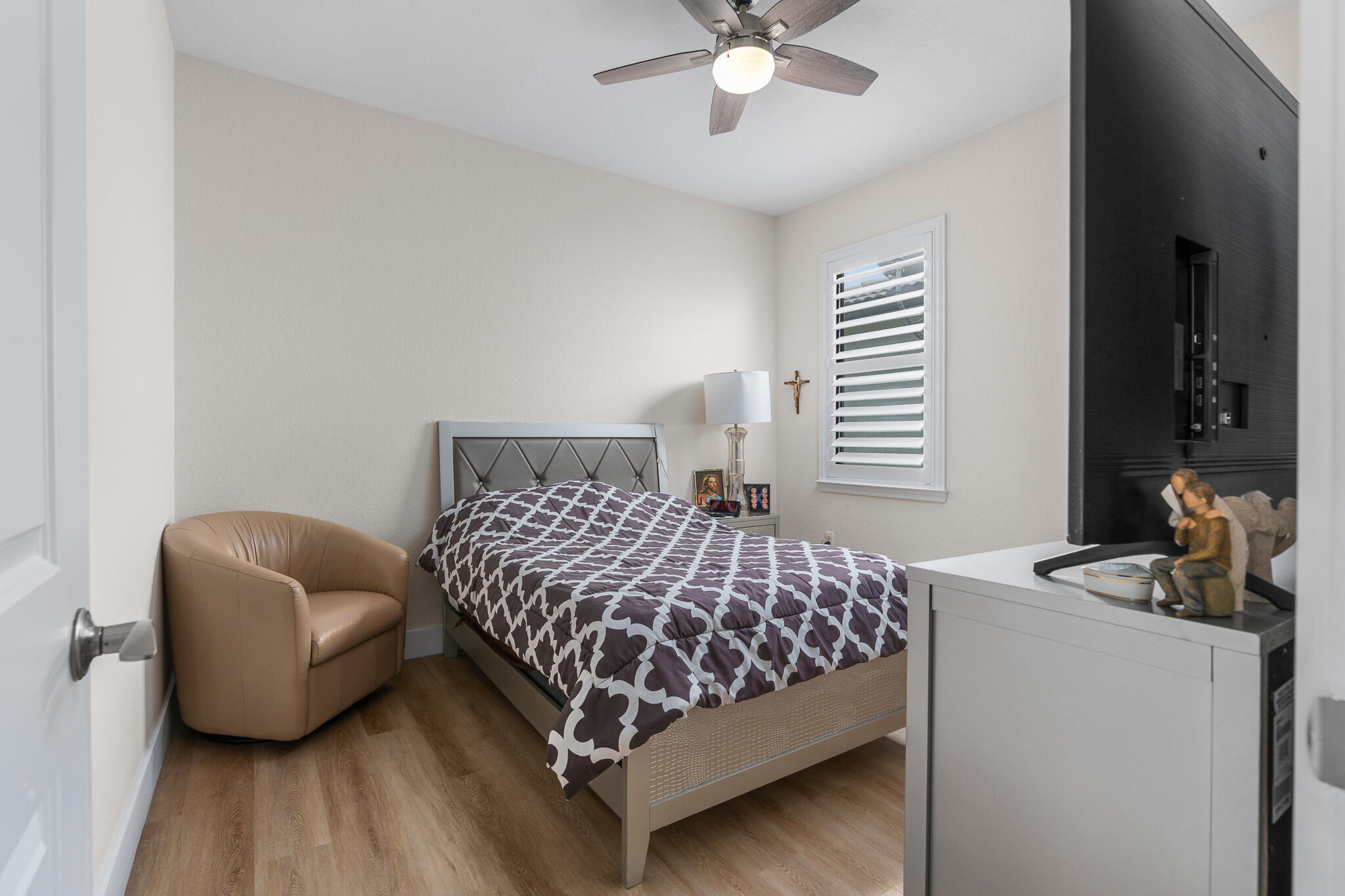 8202 Cadre Noir Road Lake Worth, FL 33467 - Photo 31 of 58 a bedroom with a bed and a chandelier