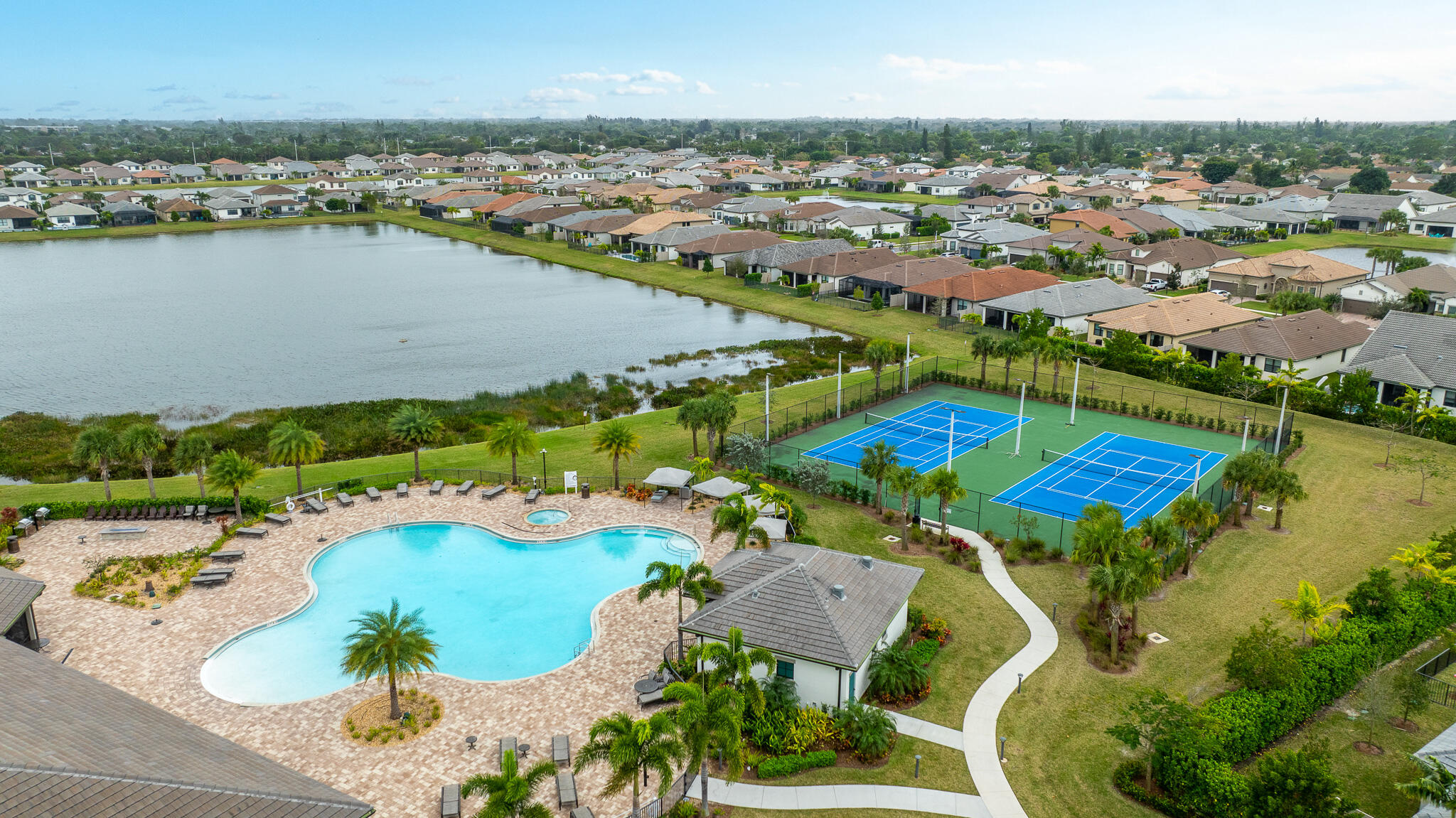 8202 Cadre Noir Road Lake Worth, FL 33467 - Photo 40 of 58 an aerial view of residential houses with outdoor space and lake view
