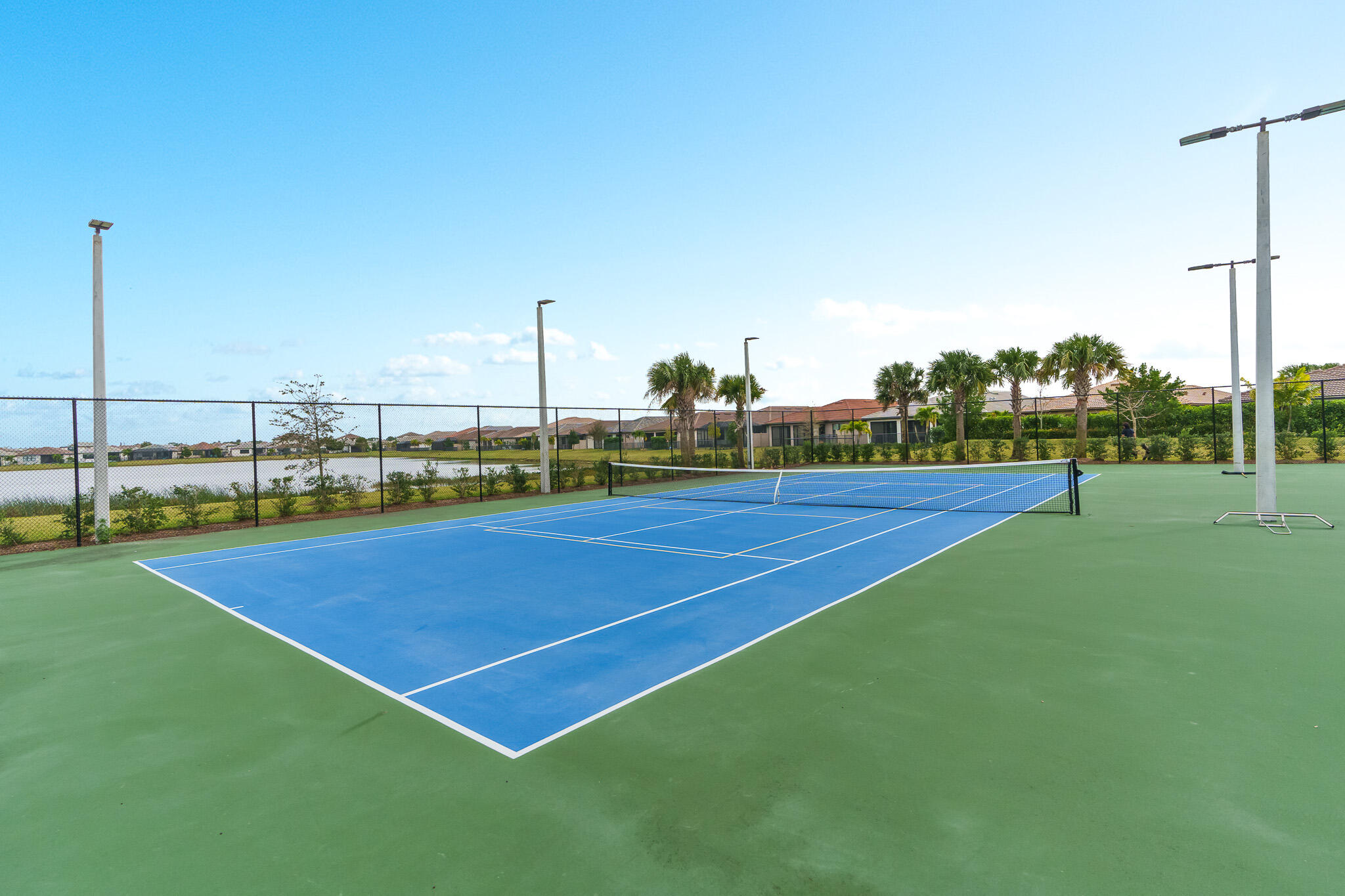 8202 Cadre Noir Road Lake Worth, FL 33467 - Photo 46 of 58 a view of an outdoor space and tennis court