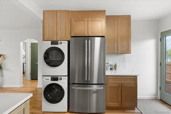 a kitchen with a refrigerator and washer