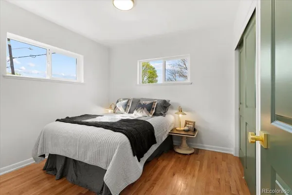 a bedroom with a bed and wooden floor