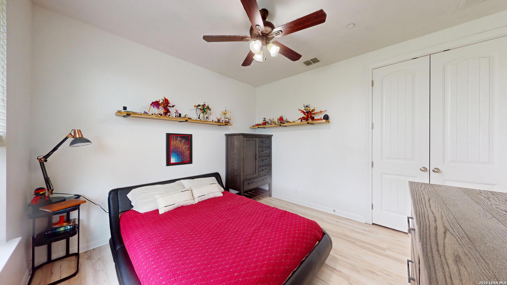 10111 Shallow Bank Converse, TX 78109 - Photo 39 of 65 a bedroom with a bed and a dresser with the shoe rack