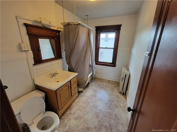 a bathroom with a sink a toilet and mirror