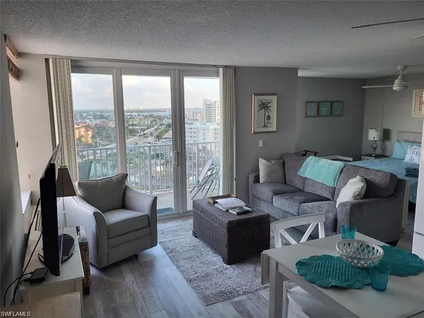 a living room with furniture and a floor to ceiling window