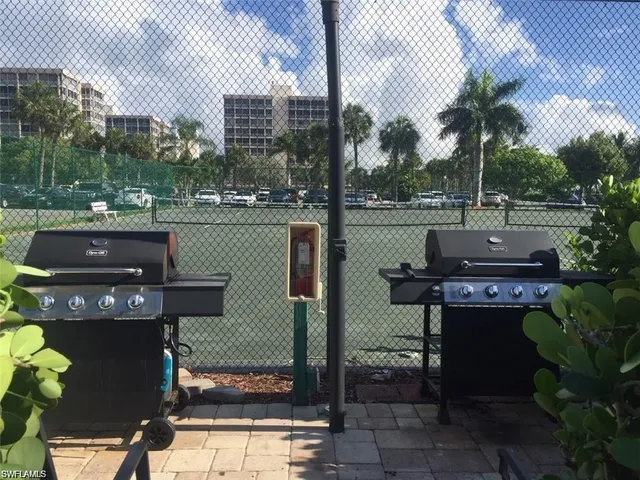 a view of a patio with table and chairs a barbeque with potted plants