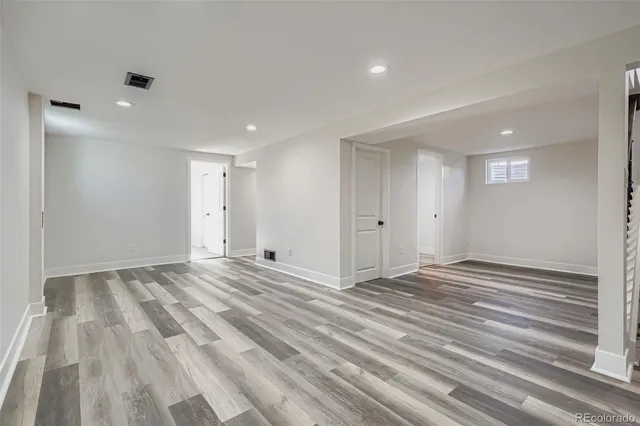 a view of empty room with wooden floor