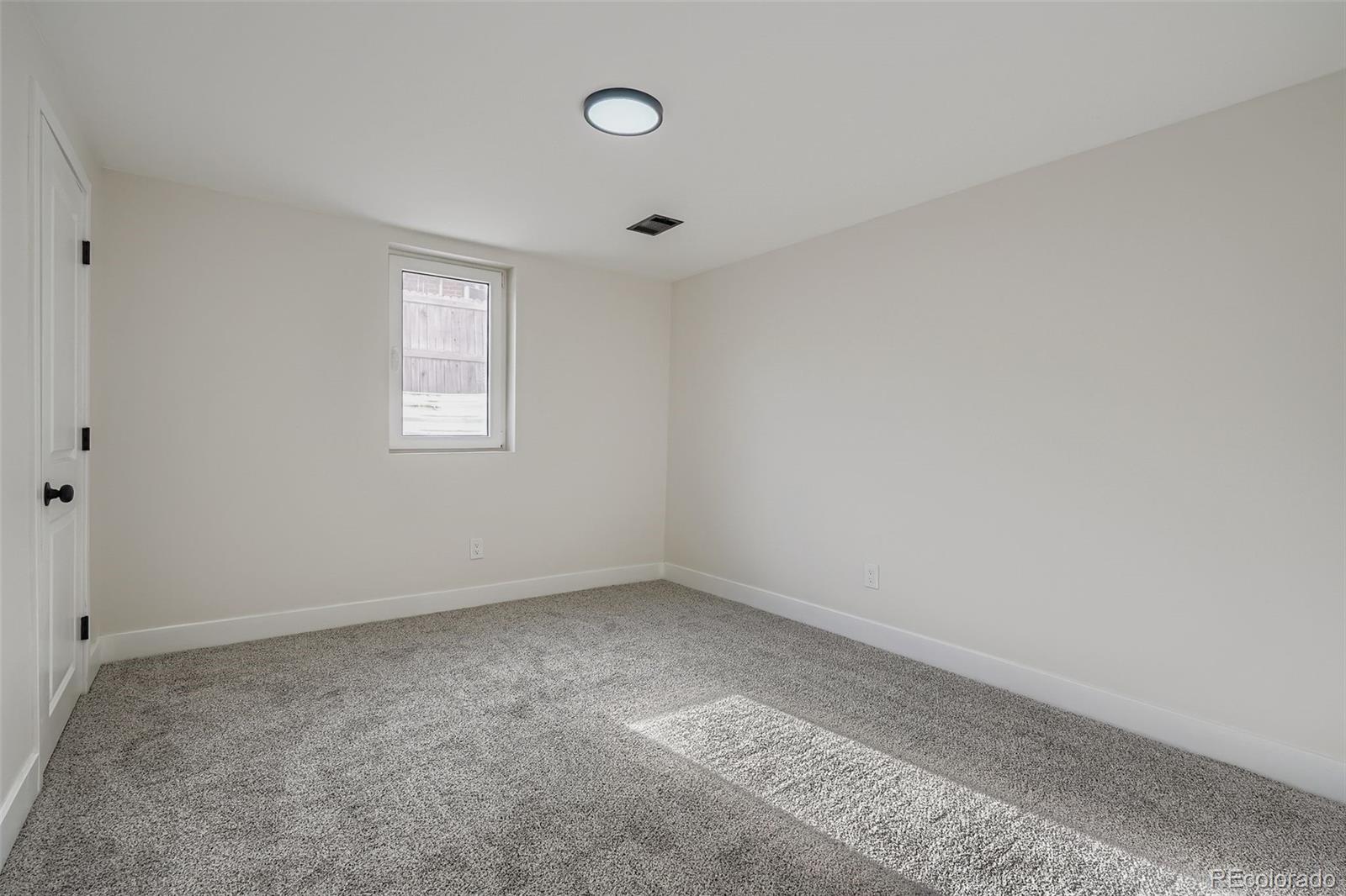 8771 Rutgers Street Westminster, CO 80031 - Photo 18 of 25 an empty room with a window