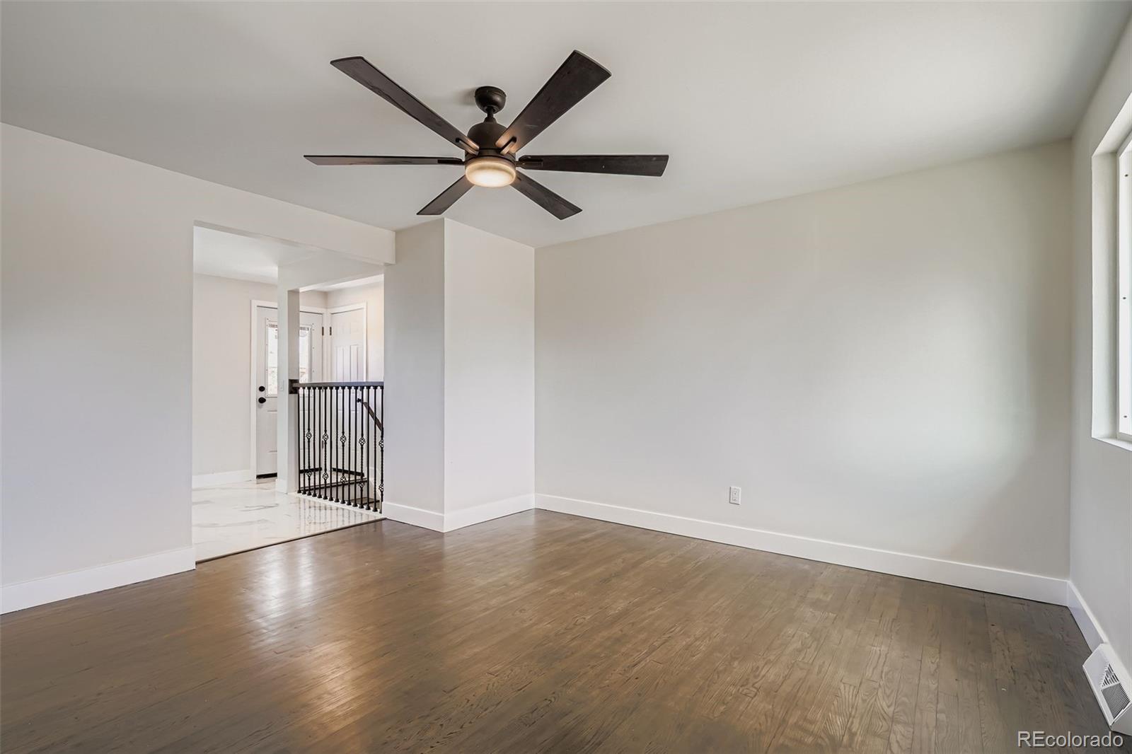 8771 Rutgers Street Westminster, CO 80031 - Photo 6 of 25 a view of a room with wooden floor and windows