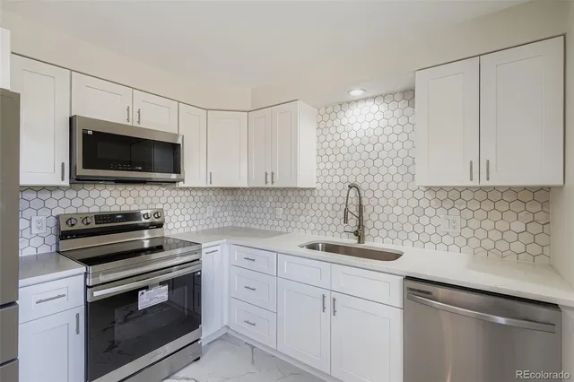a kitchen with a sink stove and microwave