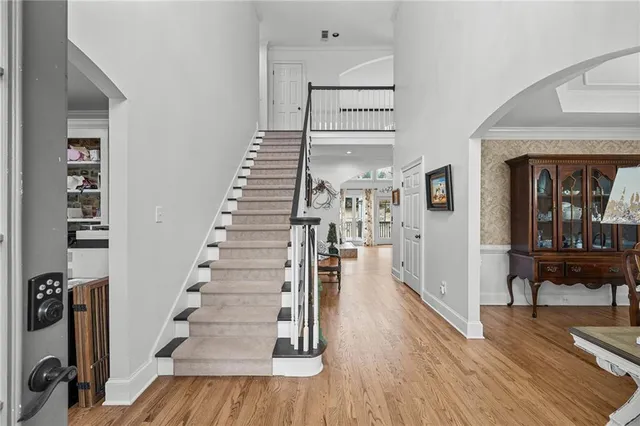 a kitchen with stainless steel appliances granite countertop a sink a stove and a wooden floors