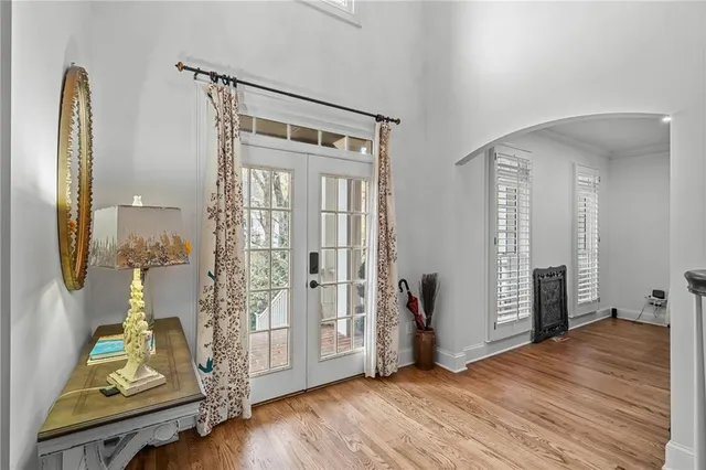 a kitchen with stainless steel appliances granite countertop a sink a stove and a wooden floors