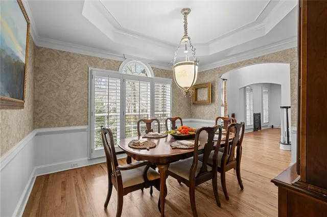 a spacious bedroom with a bed and a chandelier