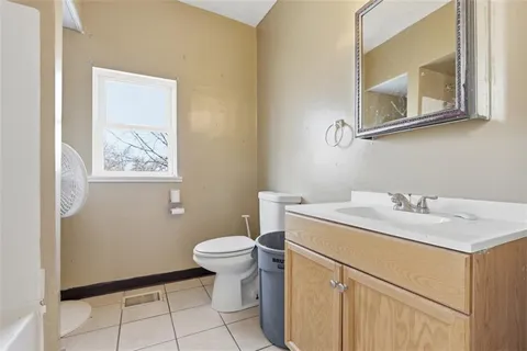 a bathroom with a sink toilet and mirror